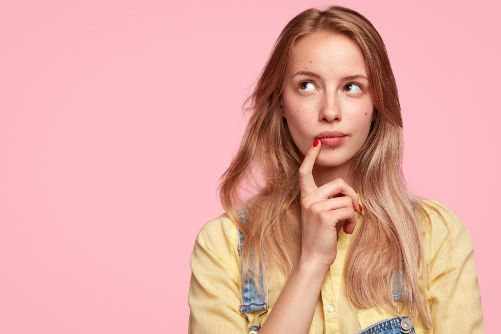 Young woman with thinking face