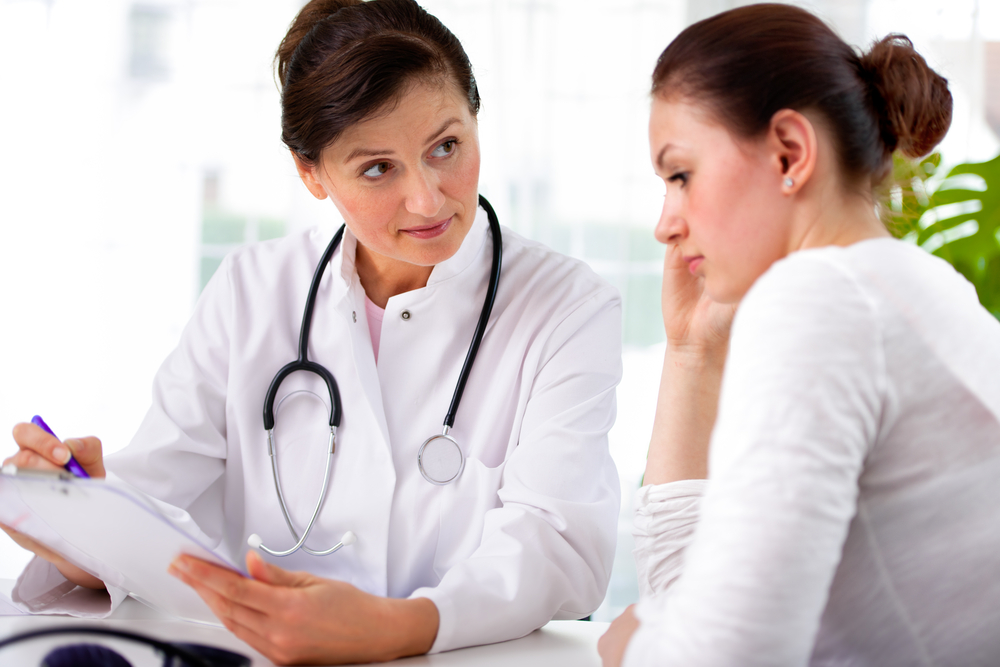 Woman discussing with her doctor.