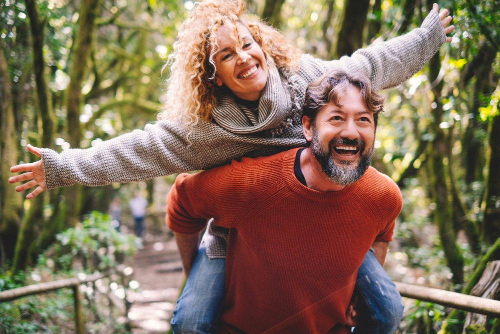 Happy couple in the woods.