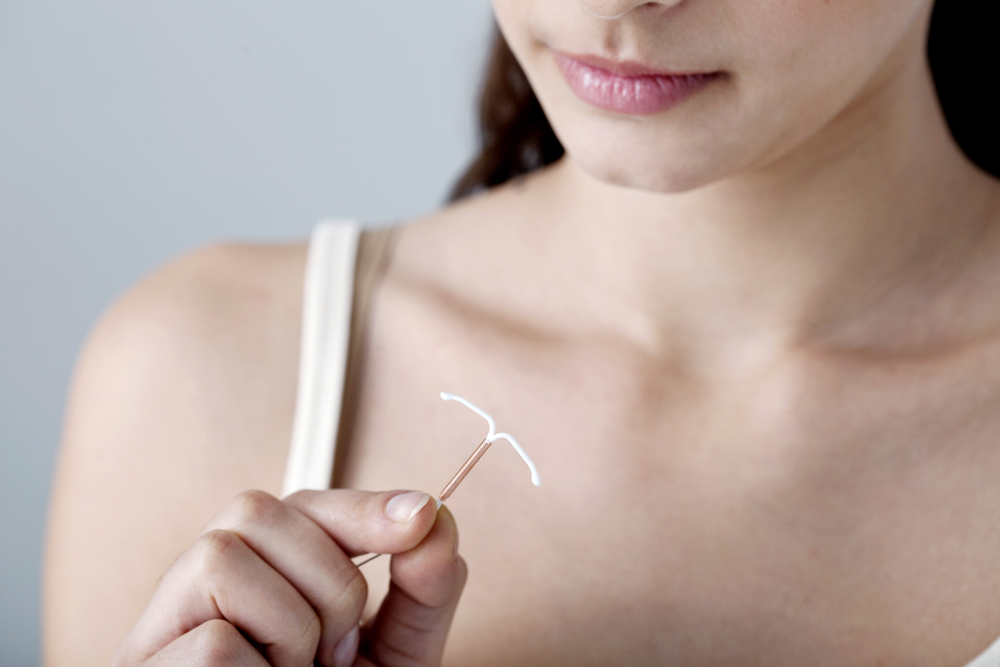 woman holding an iud.